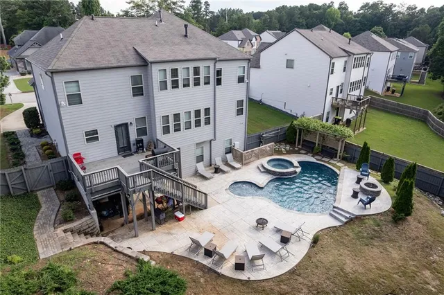 a view of a patio with table and chairs potted plants