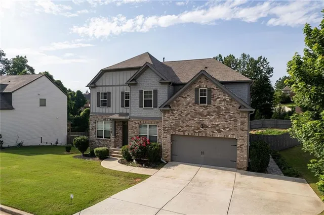 a front view of a house with a garden