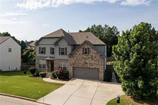 a front view of a house with a garden