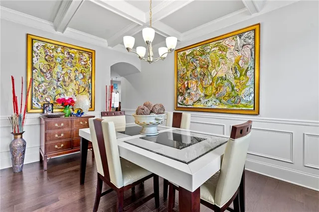 a view of a dining room with furniture and a potted plant