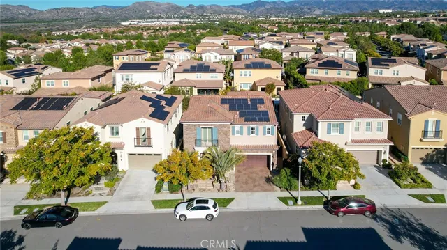 an aerial view of multiple houses with a yard