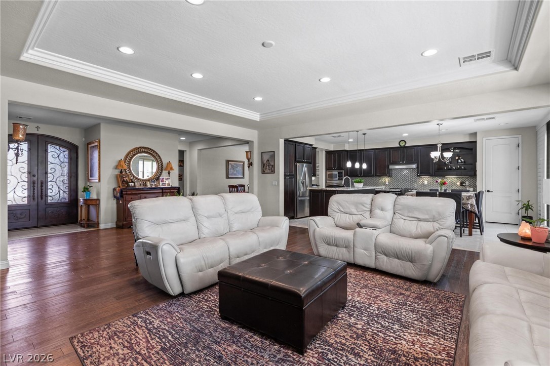 8431 Durango Ranch Court Las Vegas, NV 89113 - Photo 9 of 49 This inviting space features an open-concept living area with a gourmet kitchen and rich hardwood floors.