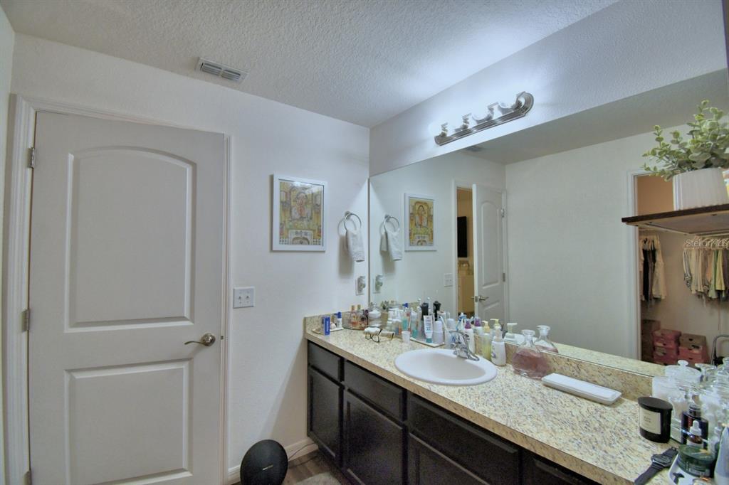 6286 Manitoba Drive Lakeland, FL 33805 - Photo 14 of 28 a bathroom with a granite countertop sink and a mirror