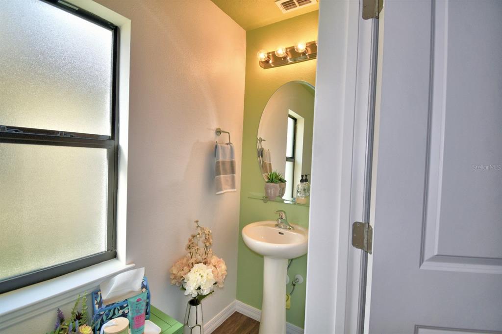 6286 Manitoba Drive Lakeland, FL 33805 - Photo 17 of 28 a bathroom with a sink and mirror