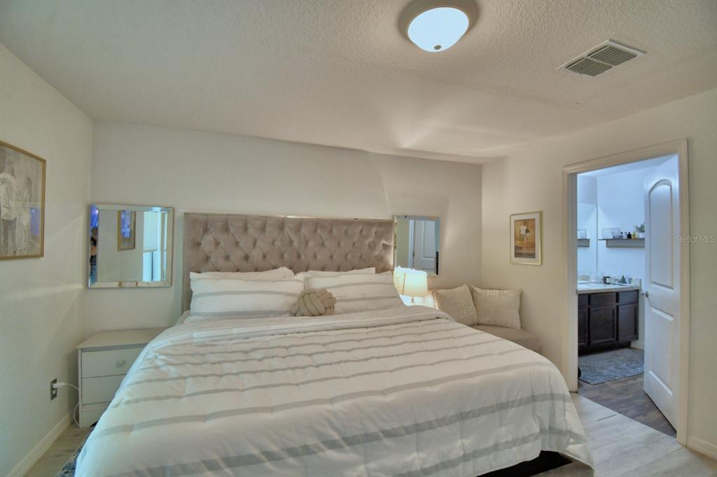 6286 Manitoba Drive Lakeland, FL 33805 - Photo 20 of 28 a bedroom with a bed and a lamp