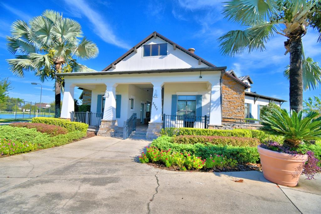 6286 Manitoba Drive Lakeland, FL 33805 - Photo 21 of 28 a front view of a house with a yard and potted plants