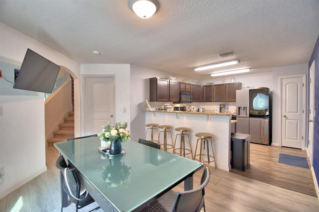 6286 Manitoba Drive Lakeland, FL 33805 - Photo 5 of 28 a kitchen with kitchen island a stove a table and chairs