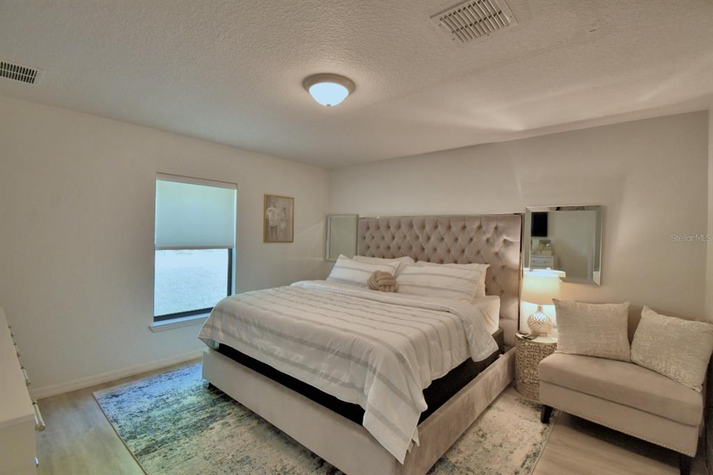 6286 Manitoba Drive Lakeland, FL 33805 - Photo 8 of 28 a bedroom with a bed and a couch