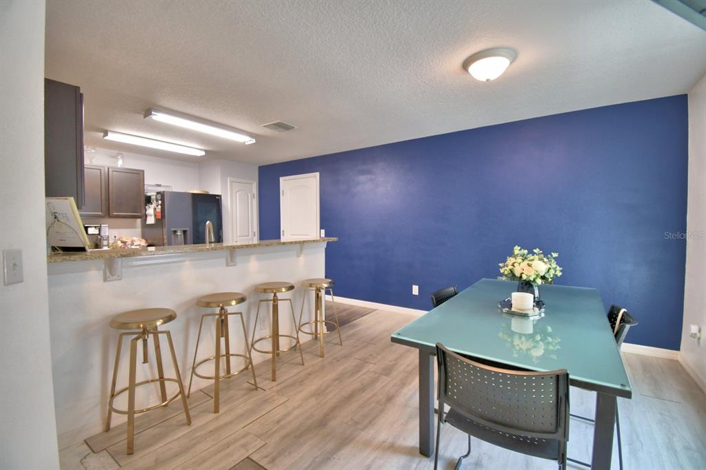 6286 Manitoba Drive Lakeland, FL 33805 - Photo 9 of 28 a kitchen with stainless steel appliances granite countertop a dining table chairs and granite counter tops