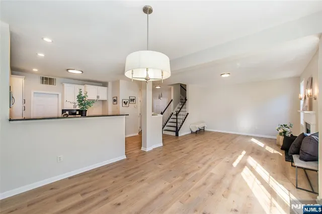 a view of a kitchen with a sink stainless steel appliances and cabinets