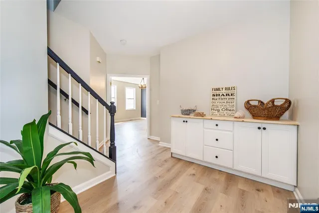 a view of a hallway with wooden floors and stairs