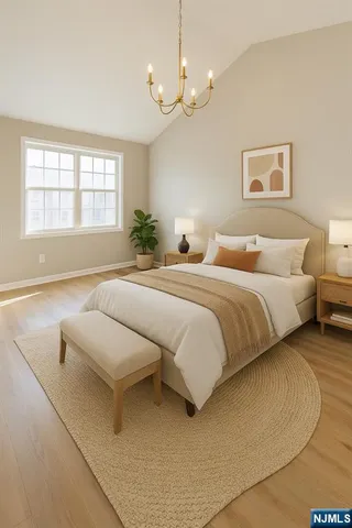 a spacious bedroom with a bed and a chandelier