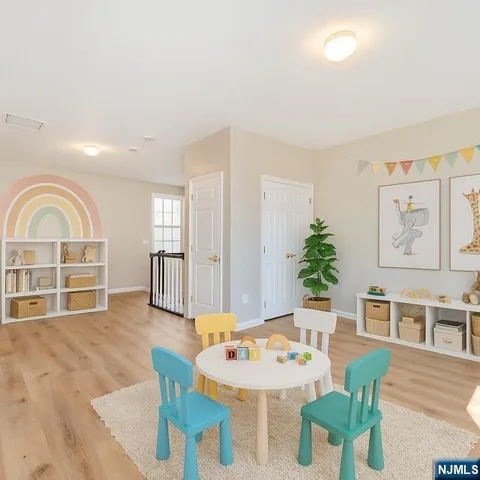 a living room with furniture a dining table and a large window with wooden floor