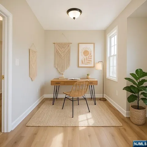 a view of a livingroom with furniture and a potted plant