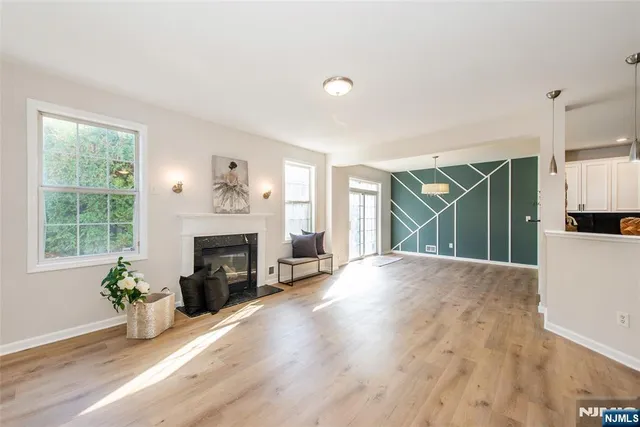 a view of a livingroom with a fireplace and window