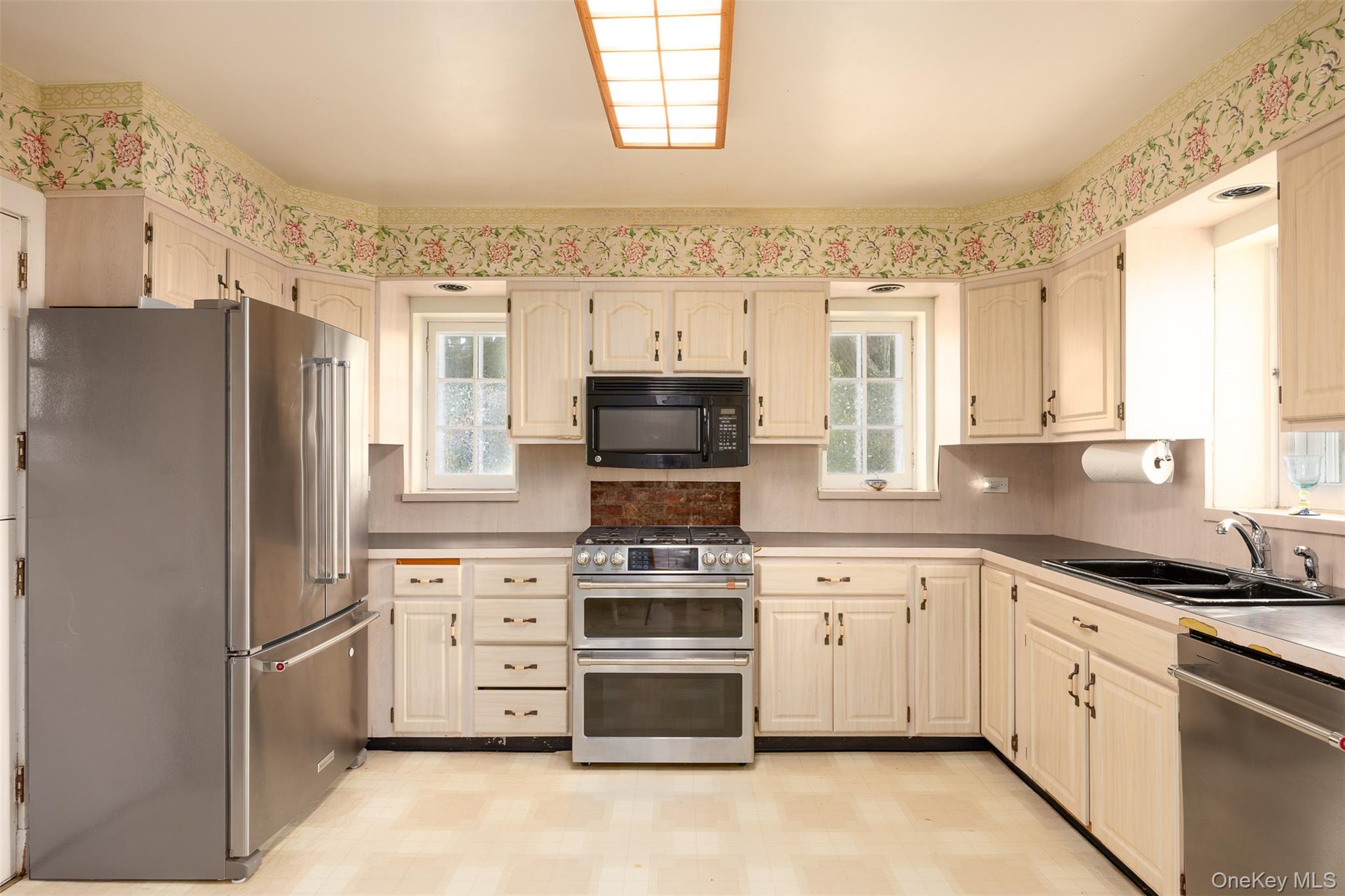 401 Woodmont Road Hopewell Junction, NY 12533 - Photo 14 of 50 a kitchen with white cabinets and appliances