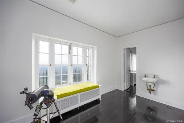 a bed sitting in a bedroom next to a fireplace and window