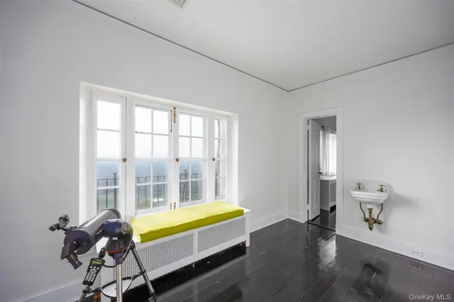 a bed sitting in a bedroom next to a fireplace and window
