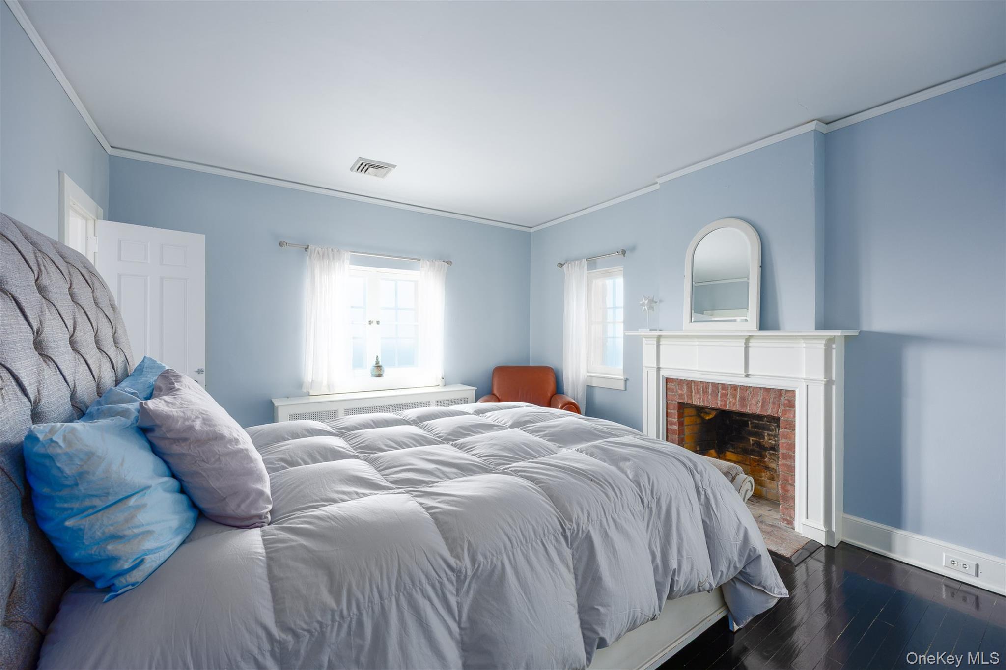 401 Woodmont Road Hopewell Junction, NY 12533 - Photo 20 of 50 a bed sitting in a bedroom next to a fireplace and window