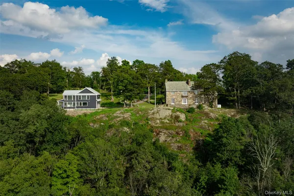 a view of a house with a yard and sitting area