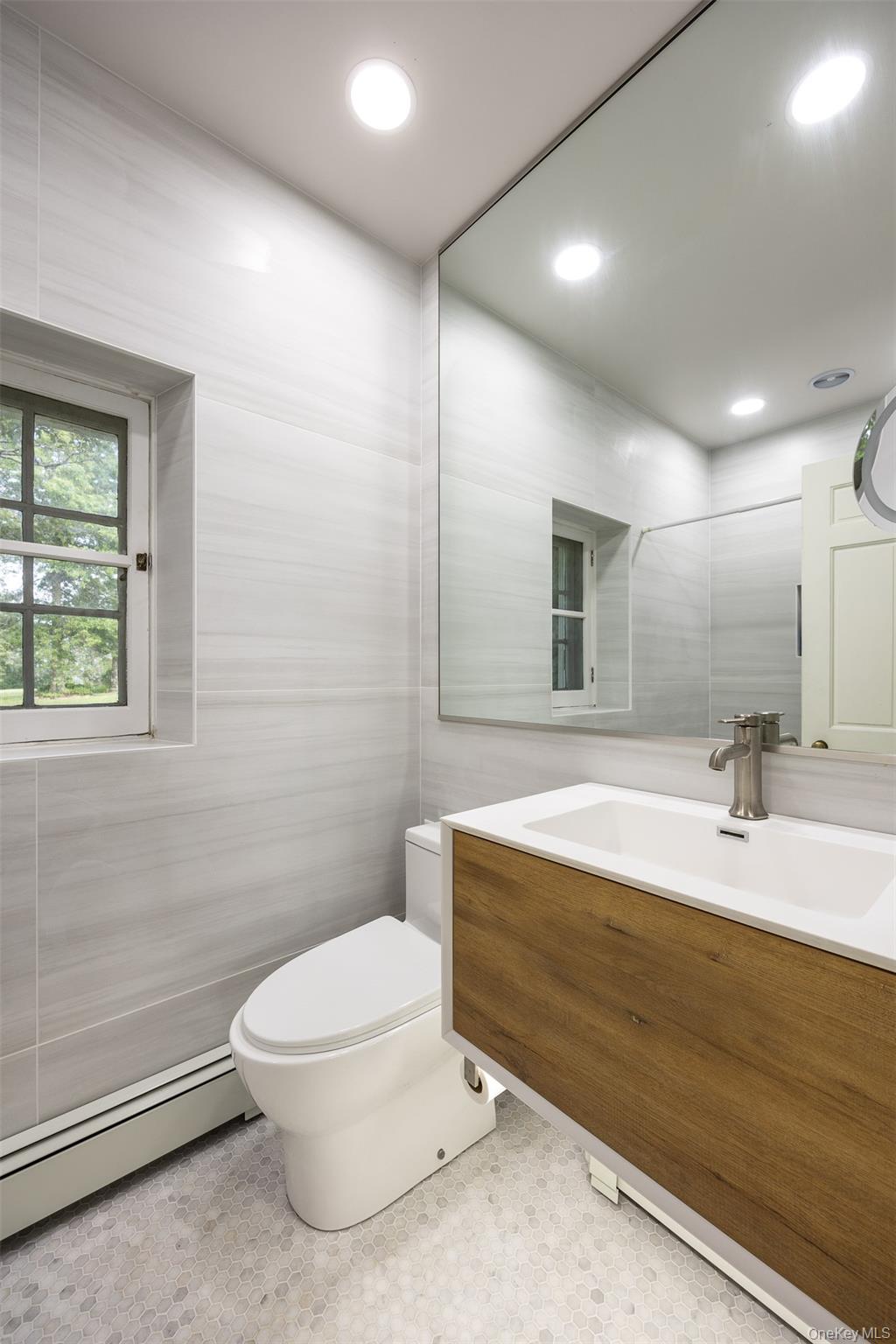 401 Woodmont Road Hopewell Junction, NY 12533 - Photo 22 of 50 a bathroom with a toilet a sink and mirror