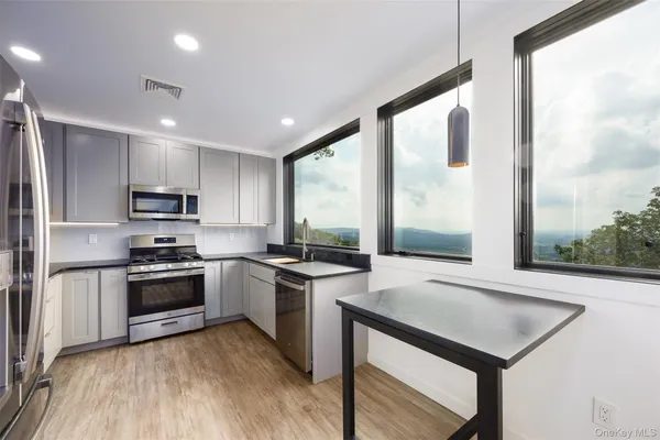 a view of a kitchen stove with furniture and fireplace