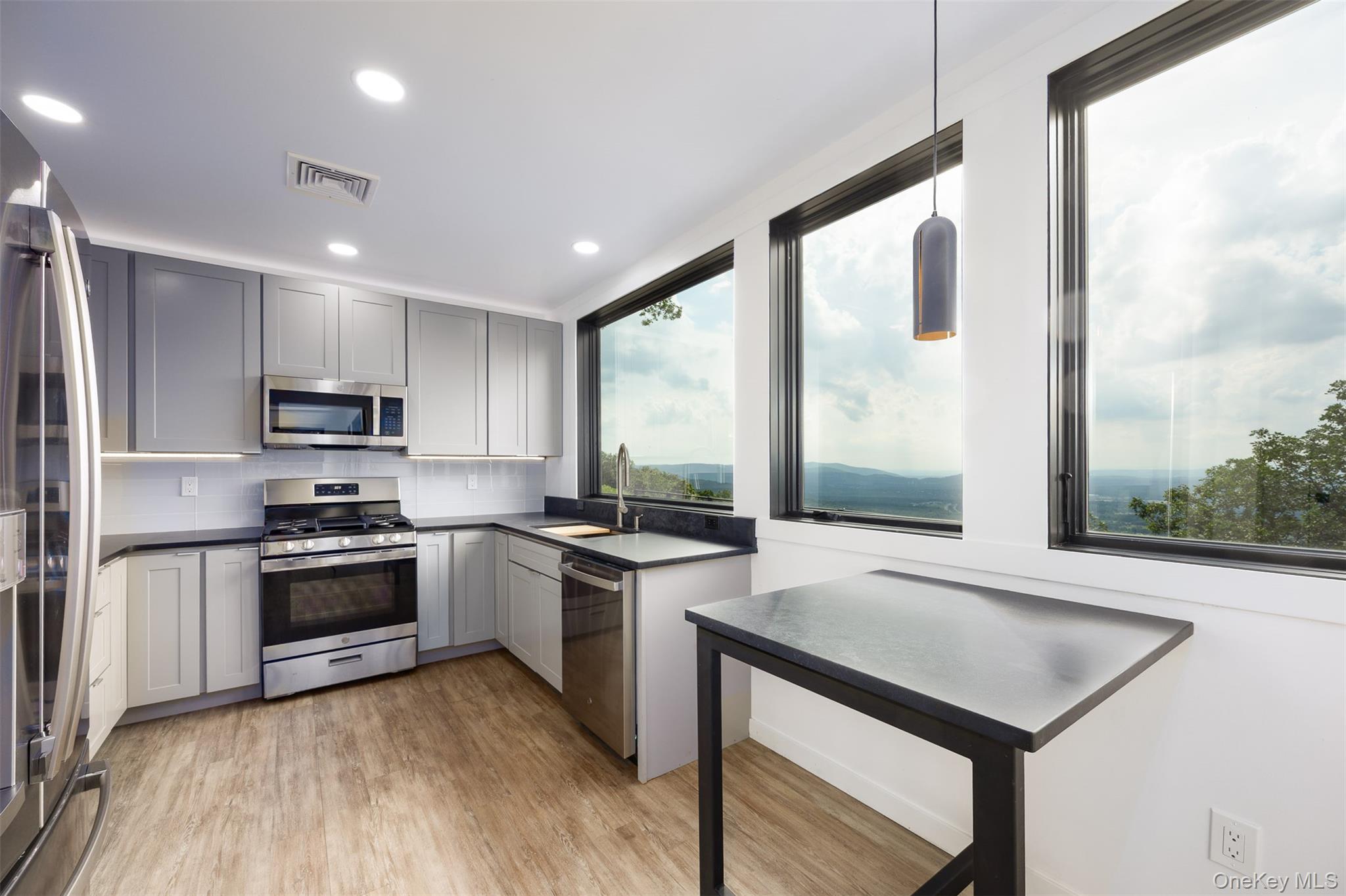401 Woodmont Road Hopewell Junction, NY 12533 - Photo 29 of 50 a kitchen with a stove a sink and a refrigerator