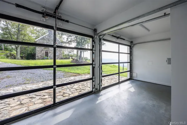 a front view of a house with a garden and trees