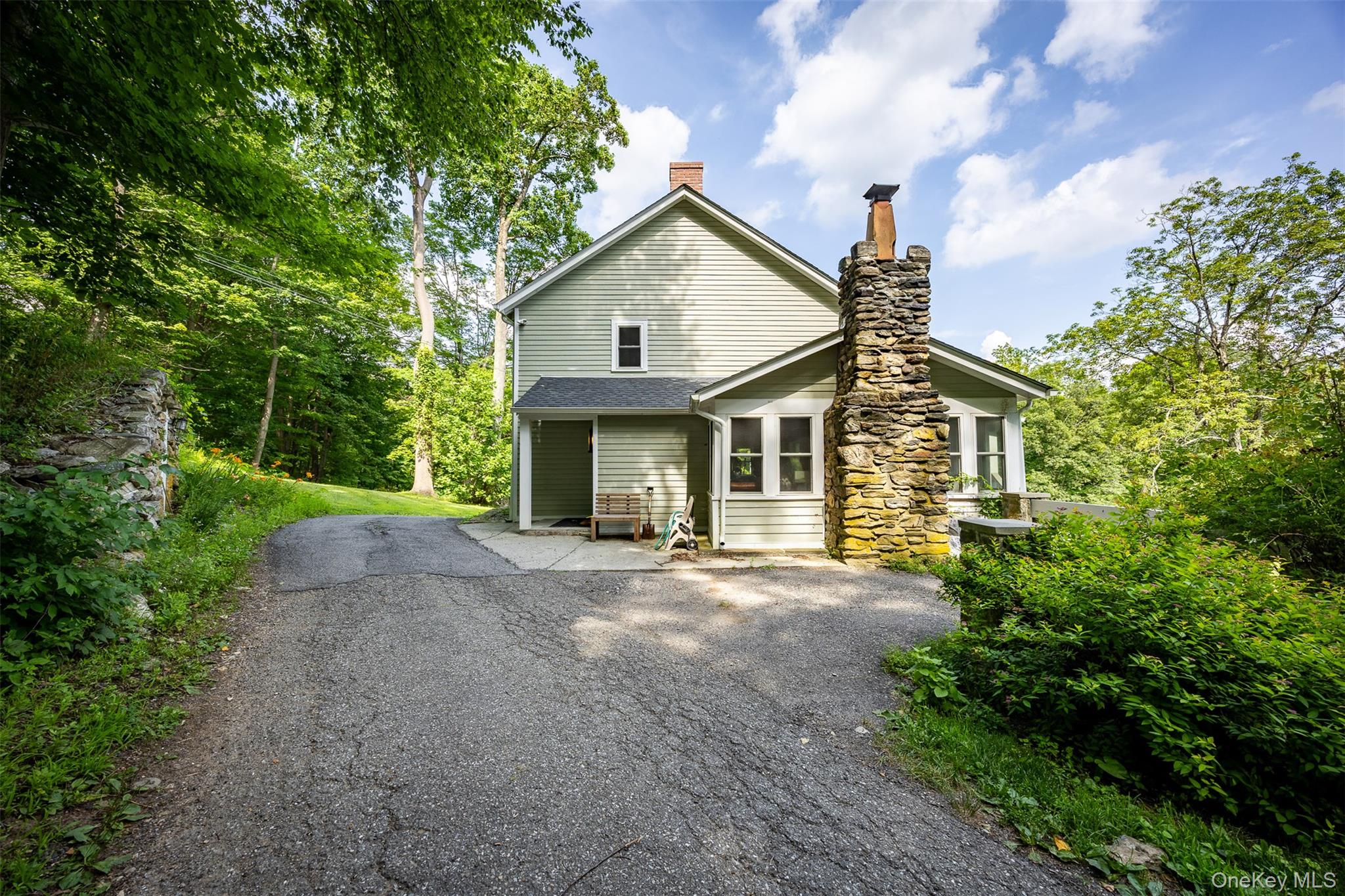 401 Woodmont Road Hopewell Junction, NY 12533 - Photo 34 of 50 a front view of a house with a garden and trees