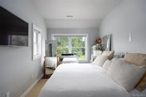 a backyard of a house with a yard and outdoor seating