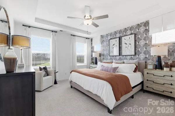 a bedroom with a bed couch and window