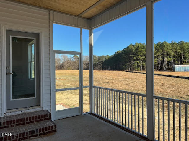 205 Big Pine Road Clayton, NC 27520 - Photo 21 of 22 a view of a balcony with a floor to ceiling window and wooden floor