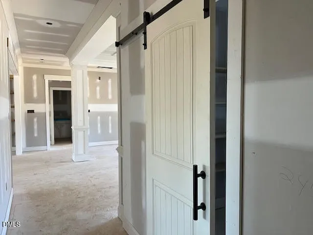 a view of a hallway with wooden floor and entryway