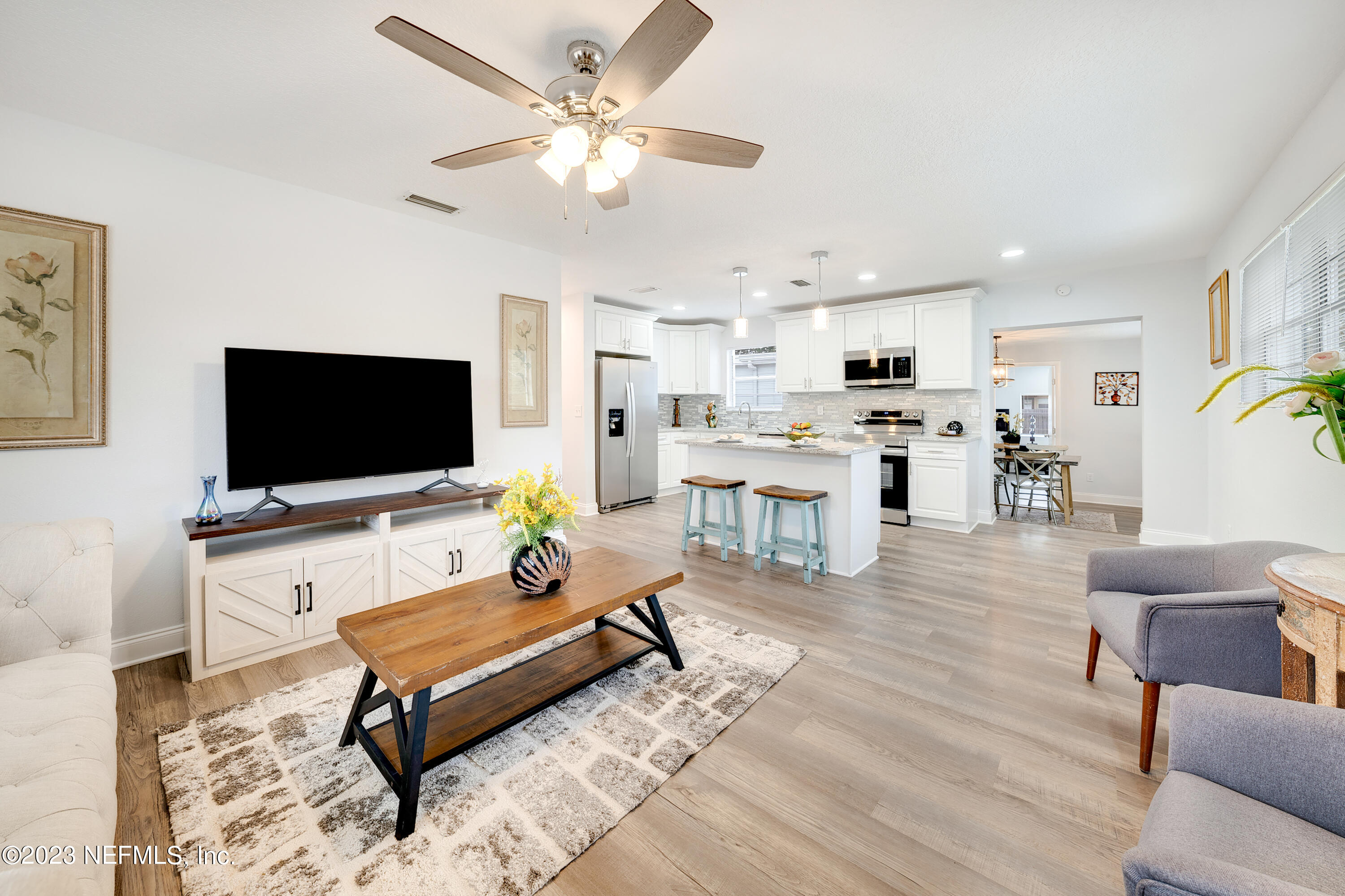 7404 Bamberg Road Jacksonville, FL 32277 - Photo 1 of 31 a living room with furniture and a flat screen tv