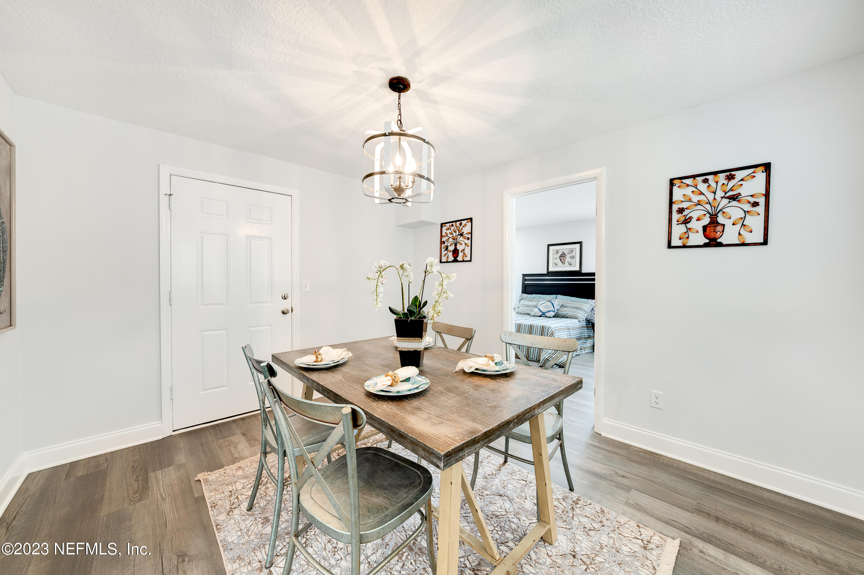7404 Bamberg Road Jacksonville, FL 32277 - Photo 13 of 31 a view of a dining room with furniture wooden floor and a chandelier