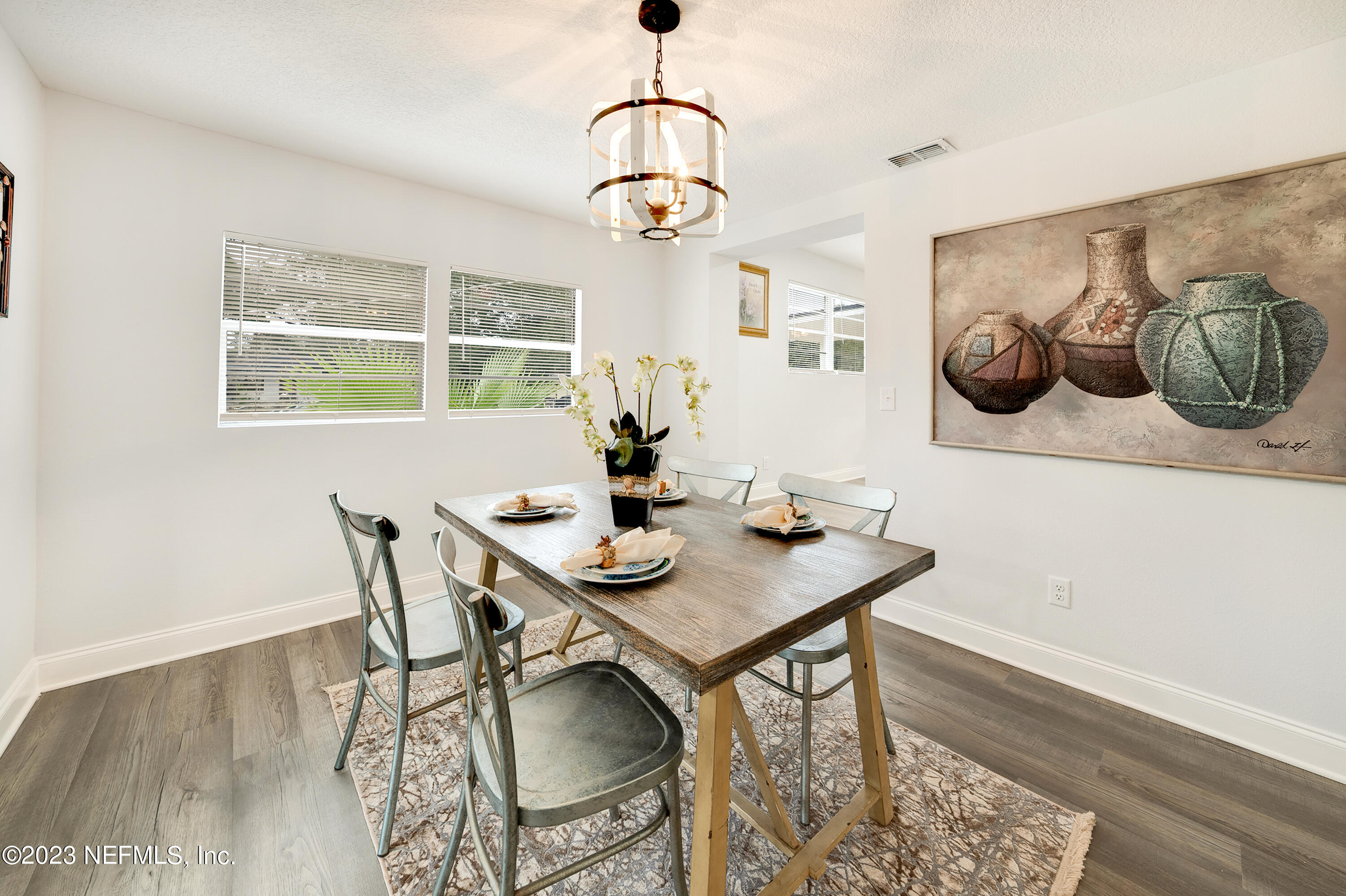 7404 Bamberg Road Jacksonville, FL 32277 - Photo 14 of 31 a view of a dining room with furniture window and wooden floor