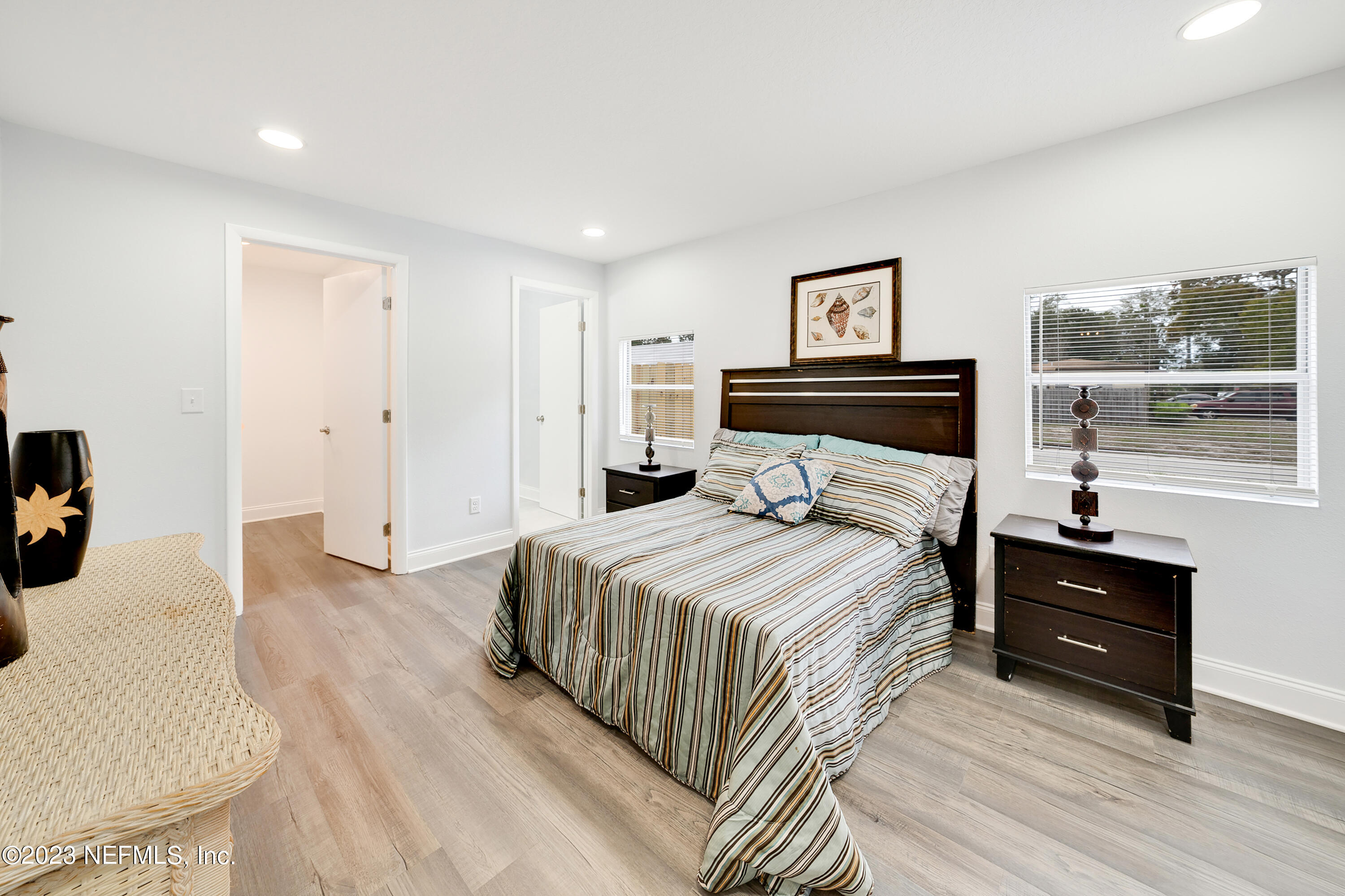 7404 Bamberg Road Jacksonville, FL 32277 - Photo 15 of 31 a bedroom with a bed and wooden floor