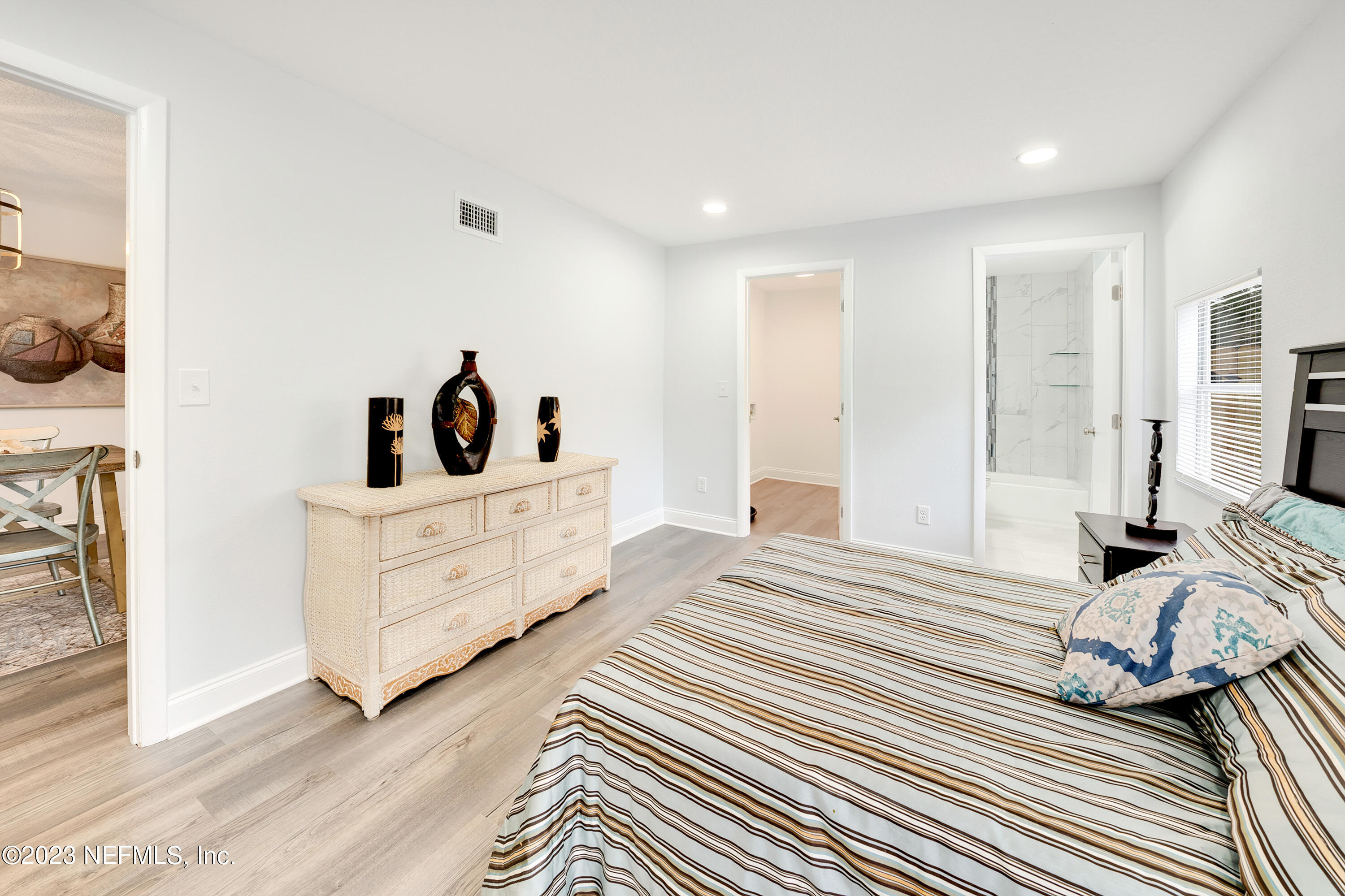 7404 Bamberg Road Jacksonville, FL 32277 - Photo 16 of 31 a bedroom with a bed and a mirror