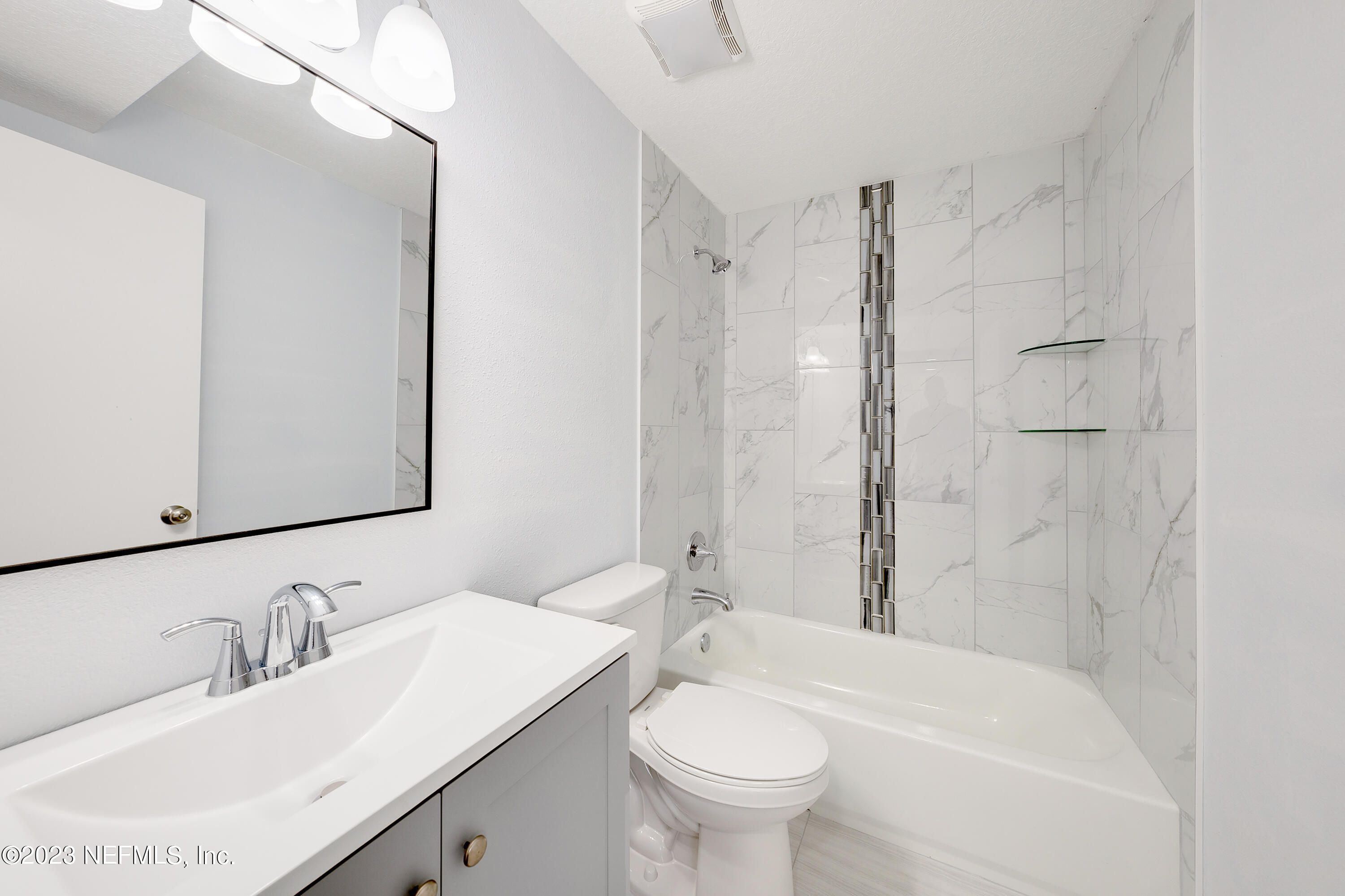 7404 Bamberg Road Jacksonville, FL 32277 - Photo 18 of 31 a bathroom with a sink toilet a mirror and shower