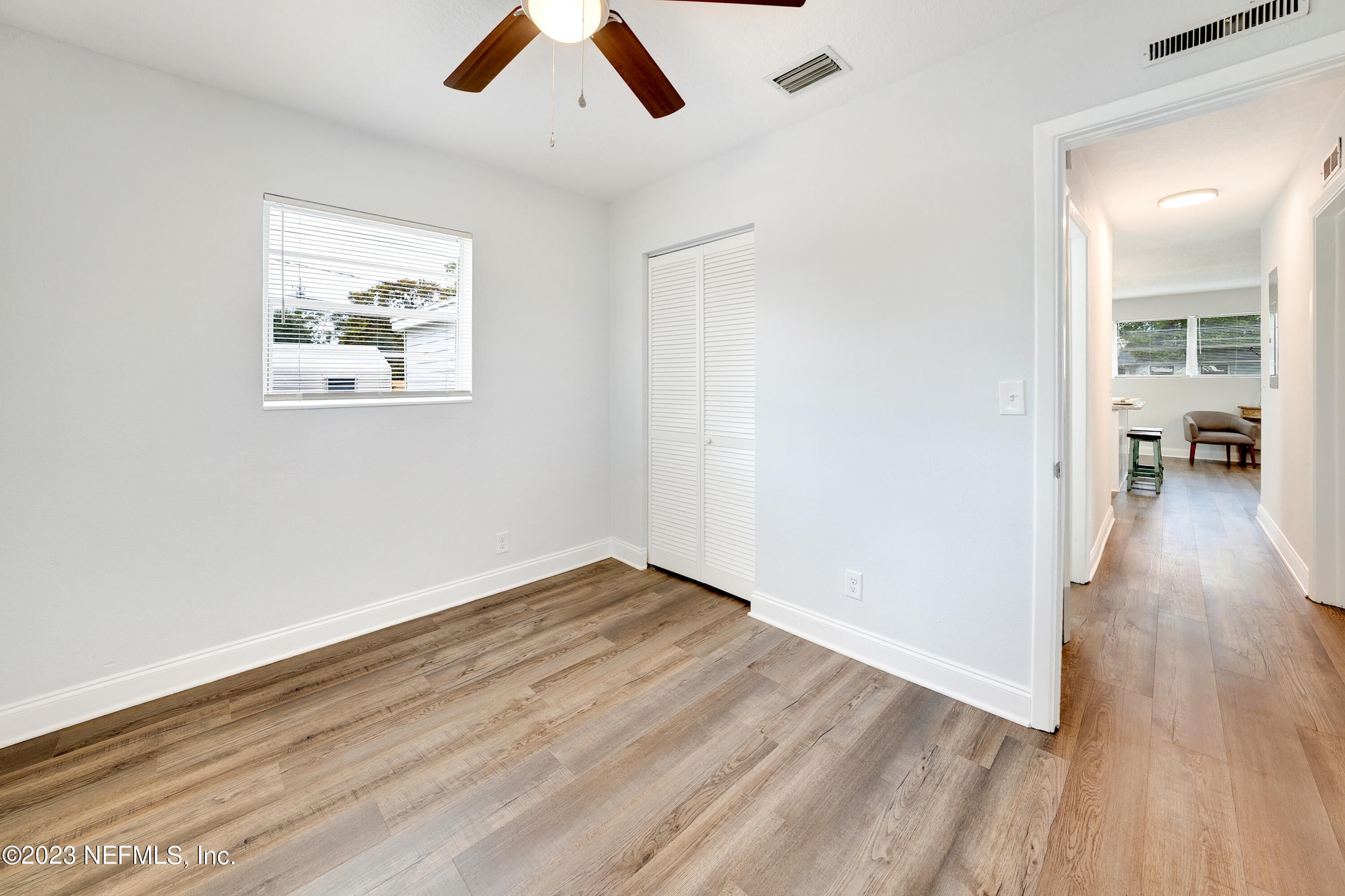 7404 Bamberg Road Jacksonville, FL 32277 - Photo 23 of 31 wooden floor in an empty room with a window