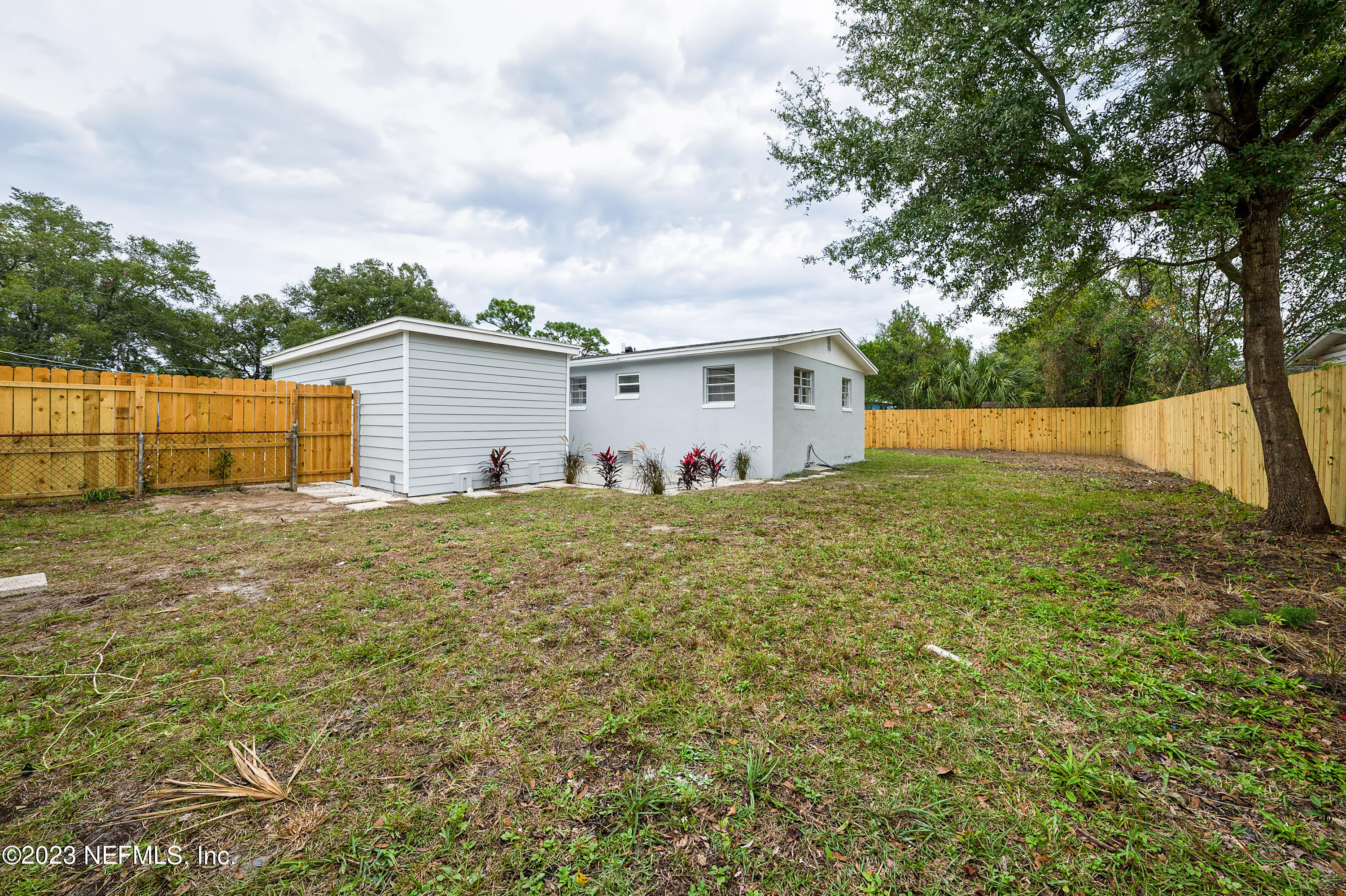 7404 Bamberg Road Jacksonville, FL 32277 - Photo 28 of 31 a view of a house with backyard and trees