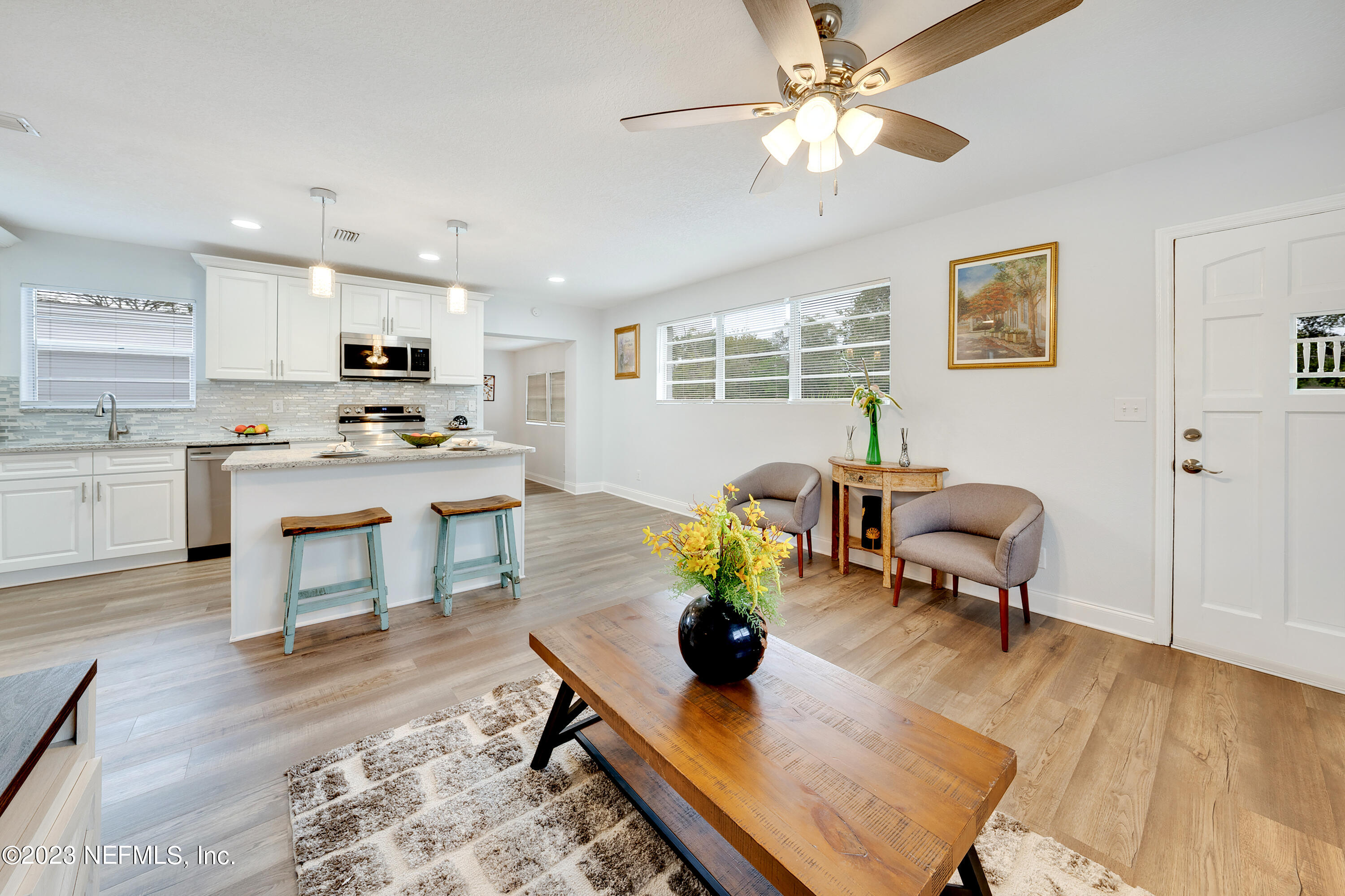 7404 Bamberg Road Jacksonville, FL 32277 - Photo 8 of 31 a living room with furniture kitchen view and a wooden floor
