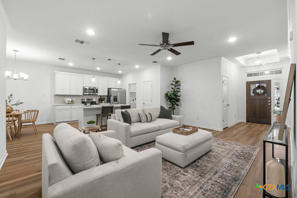 8114 Timber Hollow Lane Temple, TX 76502 - Photo 11 of 34 a living room with furniture and a chandelier