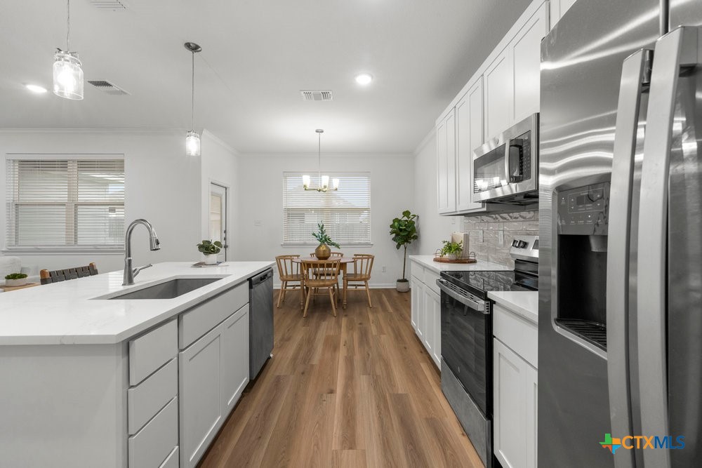 8114 Timber Hollow Lane Temple, TX 76502 - Photo 13 of 34 a kitchen with stainless steel appliances granite countertop sink stove top oven and cabinets