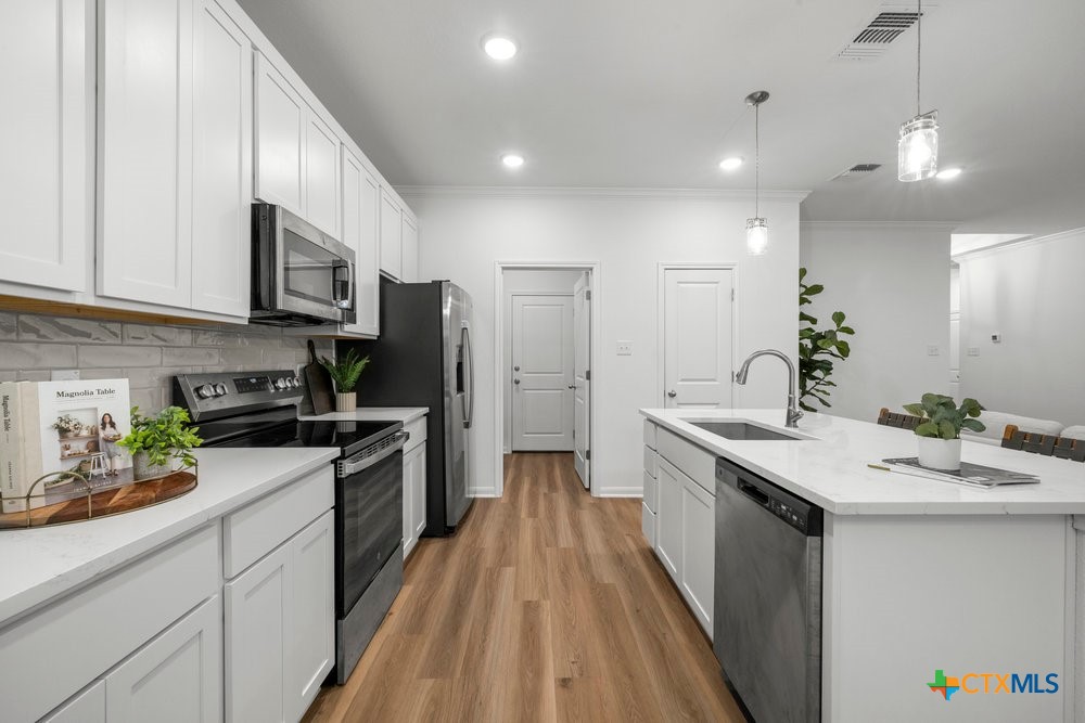 8114 Timber Hollow Lane Temple, TX 76502 - Photo 15 of 34 a kitchen with a sink stove and refrigerator