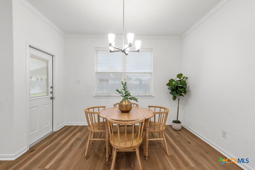 8114 Timber Hollow Lane Temple, TX 76502 - Photo 19 of 34 a view of a dining room with furniture wooden floor and a chandelier