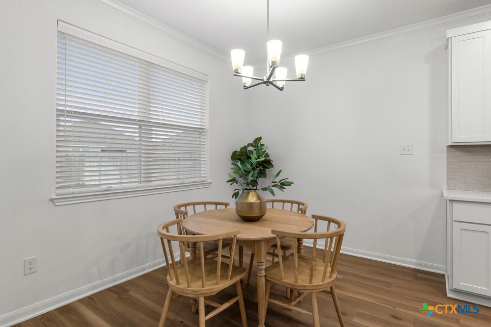 8114 Timber Hollow Lane Temple, TX 76502 - Photo 20 of 34 a dining room with furniture and wooden floor