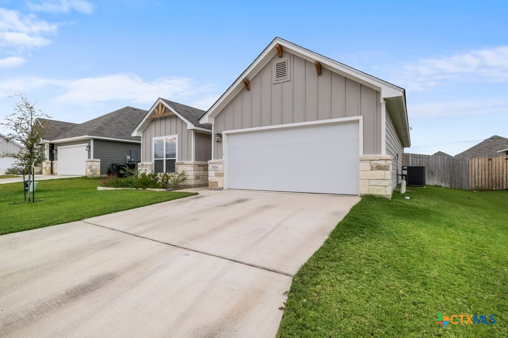 8114 Timber Hollow Lane Temple, TX 76502 - Photo 2 of 34 a front view of a house with a yard and garage