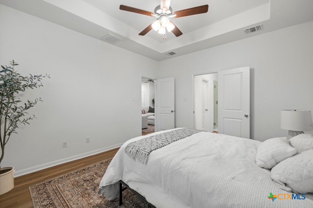 8114 Timber Hollow Lane Temple, TX 76502 - Photo 24 of 34 a bedroom with a bed and a chandelier fan