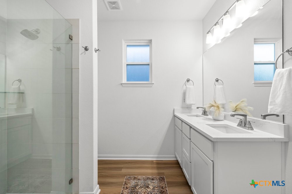 8114 Timber Hollow Lane Temple, TX 76502 - Photo 27 of 34 a bathroom with a double vanity sink and mirror